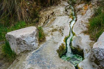 Hot springs at Bagni San Filippo, with calcium carbonate deposits surrounding the thermal water