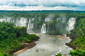 Iguazu Falls seen from the Brazilian side with tousist boat on small lake