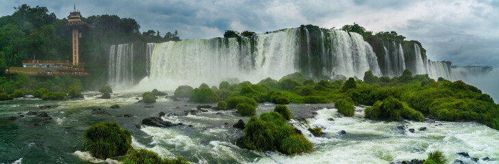 Fototapeta na wymiar Iguazu Falls seen from the Brazilian side with tousist boat on small lake