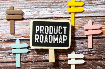 Education concept.Text PRODUCT ROADMAP writing on notepaper with pen and calculator on blue background.