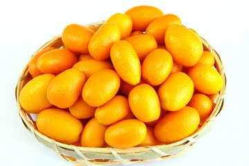 Kumquats in a basket on a white background

