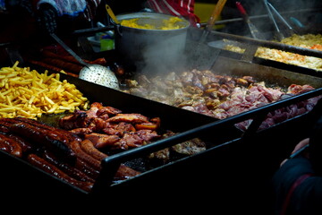 Romanian traditional food being cooked outdoor for sale at Christmas market in Bucharest in the...