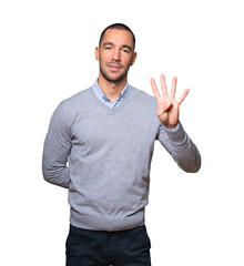Young man making a number four gesture