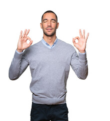 Happy young man doing a gesture of meditation