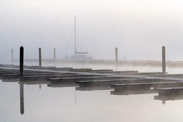 Foggy Morning at the boat dock with a sailboat