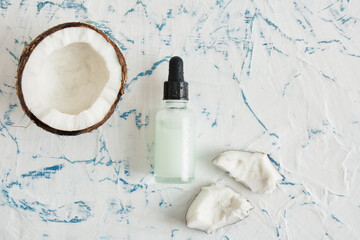 Natural organic coconut oil or serum in amber glass dropper bottle