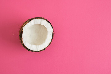 half coconuts on pink background copy space