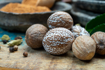 Nutmeg powder. Macro view whole nuts and grated muscat nuts on vintage background.