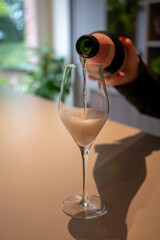 Tasting of rose champagne sparkling wine produced by traditional method in underground caves in Champagne, France