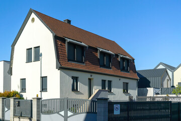 Modern house with closed windows blinds - clear blue sky above - rural real estate property for sale