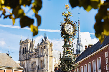 old street clock in front of Amiens Cathedral, Hauts-de-France, France - obrazy, fototapety, plakaty