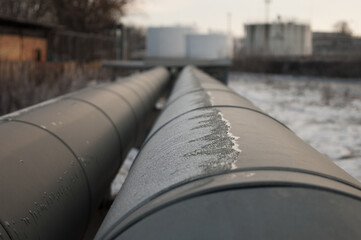 the pipeline, in the photo, is a winding gray pipeline in close-up, the photo was taken in winter