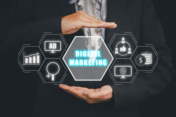 Digital marketing technology concept, Business person hand holding VR screen digital marketing icon on dark background, Internet, Online, Search Engine Optimisation, SEO, Video Advertising.