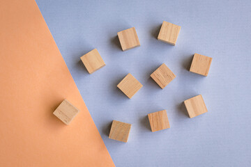 Wooden blocks on blue and orange background. Leadership, human resources, team or hiring concept.
