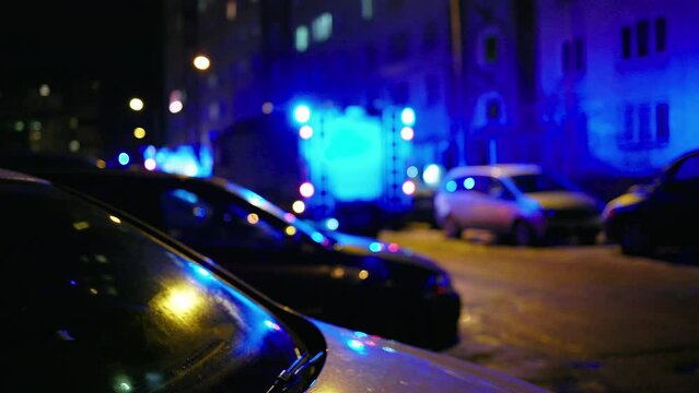 Defocused bokeh: Emergency firefighter truck scene with flashing siren at night