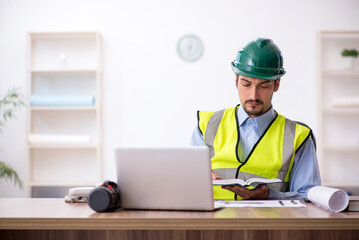 Young male architect working in the office