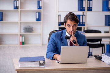Fototapeta premium Young male employee and too much work in the office