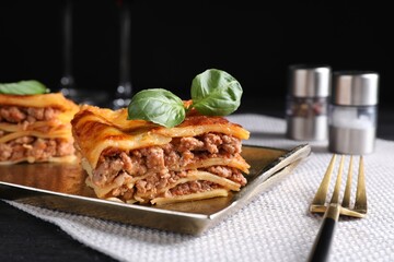 Delicious cooked lasagna served on black table
