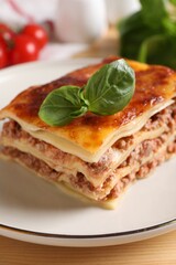 Delicious cooked lasagna served on table, closeup