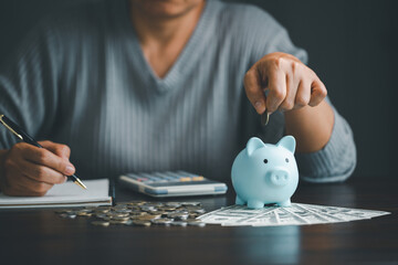 Saving investment banking finance concept. Stack of coins with piggy bank on the table. Growth of...