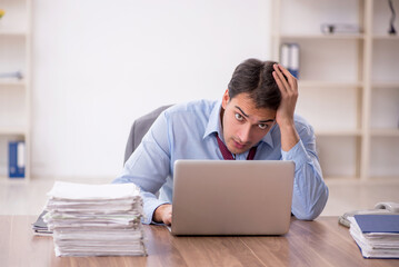 Young male employee working in the office