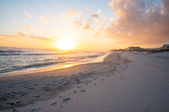 Footsteps on beach at sunset