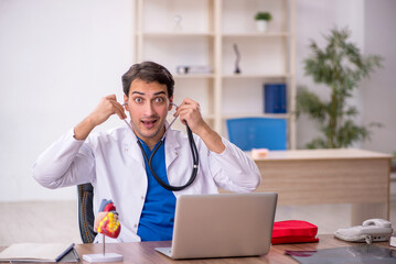 Young male doctor cardiologist working in the clinic