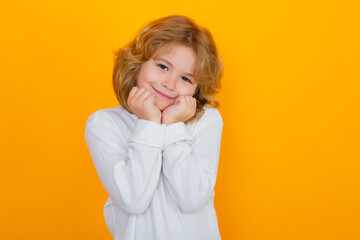 Cute kid boy dream on yellow isolated studio background. Child daydreaming and imagination. Kids mind imagine fantasy.