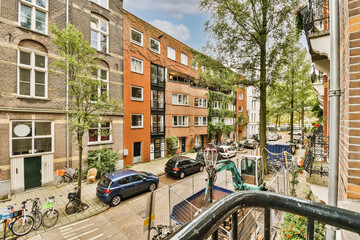 an urban street with parked cars and bicycles in amsterdam, the netherlands - stockfoorenlimm com © Casa imágenes