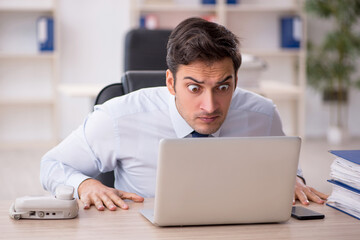 Young male employee working in the office