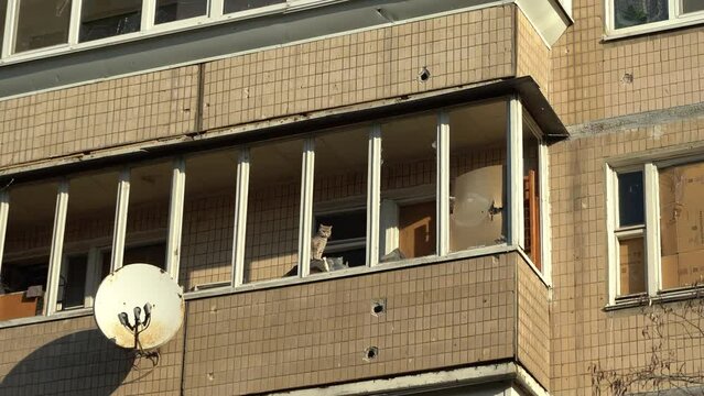 Consequences of rocket attack on the center of Ukraine. Funnel from a drone explosion. Attack of Iranian Shahed 136 drones on Kyiv. Damaged residential building. Broken windows and holes from debris. 