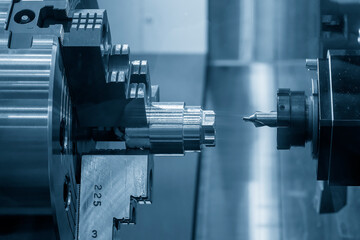 The multi-tasking CNC lathe machine  chamfer cutting the metal shaft parts by milling turret.