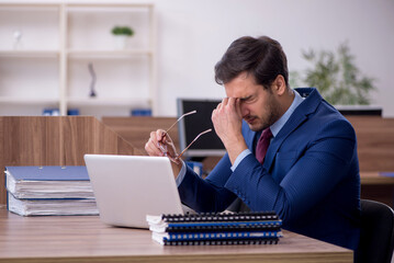 Young male employee working in the office
