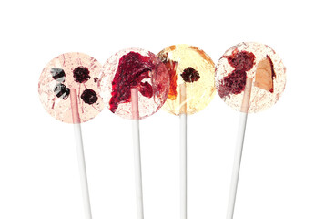 Sweet colorful lollipops with berries on white background