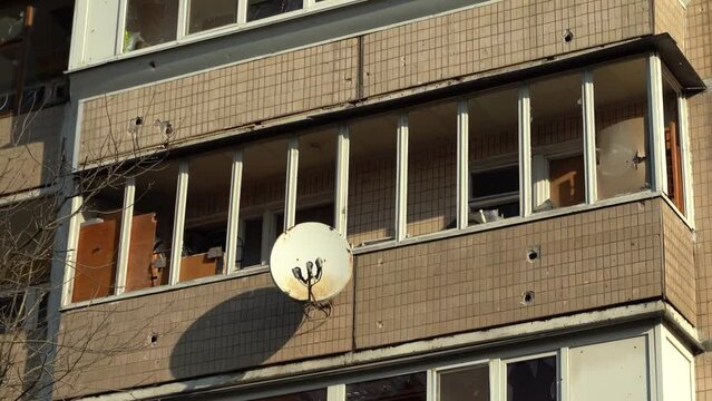 Consequences of rocket attack on the center of Ukraine. Funnel from a drone explosion. Attack of Iranian Shahed 136 drones on Kyiv. Damaged residential building. Broken windows and holes from debris. 