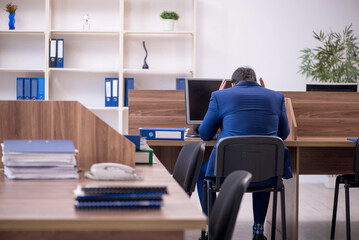 Young male employee working in the office