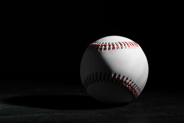 Baseball ball on black background, space for text. Sports game