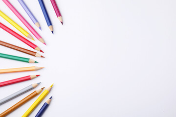 Colorful wooden pencils on white background, flat lay. Space for text