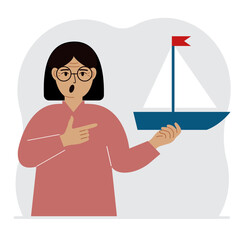 A woman holds a sailing yacht in his hand. Concepts of freedom, hope and big plans. Hobby, sport or business.