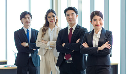 Millennial Asian young professional successful male female businessmen businesswomen in formal suit standing smiling side by side smiling in company office workstation. © Bangkok Click Studio