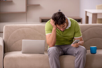 Young man watching tv at home