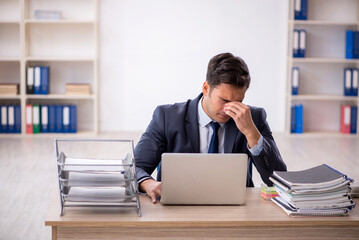 Young male employee working in the office