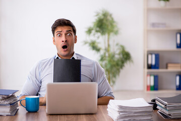 Young male employee working in the office