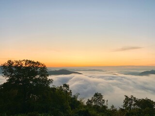 Beautiful sunrise on the Mekong River and mist at Phu Huay Isan, Nong Khai Province, Thailand
