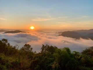 Beautiful sunrise on the Mekong River and mist at Phu Huay Isan, Nong Khai Province, Thailand