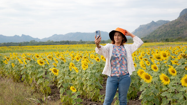 Portrait of Asia women traveling in the sunflowers field