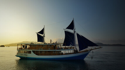 Aerial top view of a traditional boat in beautiful sea bay with turquoise crystal clear water, 