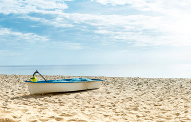 Fototapeta na wymiar Fishing boat on tropical sandy beach, summer outdoor day light