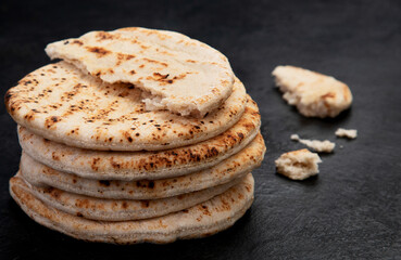 .Pita bread on dark background. Arabic, lebanese bread, traditional food.