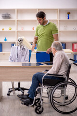 Old patient in wheel-chair visiting skeleton doctor
